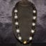 35 inches long Polished Black Kui Nut Lei with 24K Gold Center Kukui surrounded with Ten 99% Pure Fine Silver Kukui Nuts